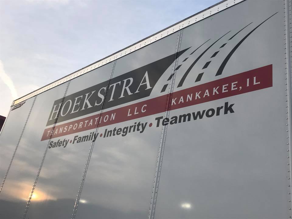 Side of semi-truck transport with Hoekstra Tranportation LLC Branding